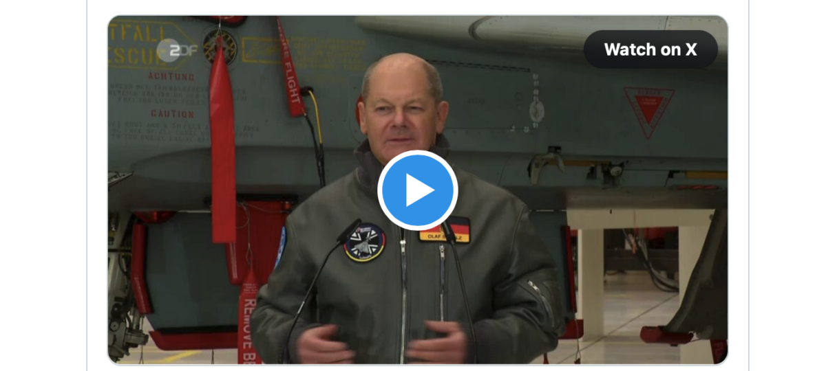 Witz der Woche! Der Kriegsdienstverweigerer Scholz präsentiert sich in militärischer Pilotenjacke vor einem Kampfjet!